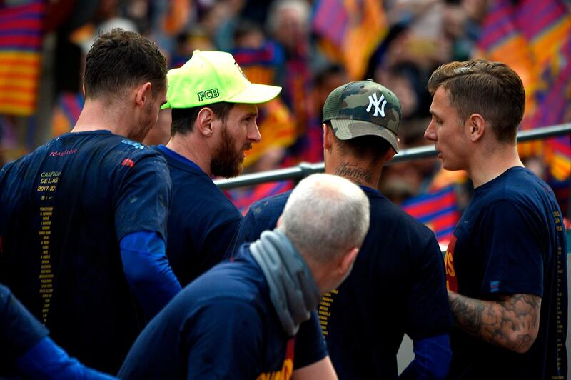Lionel Messi, second left, and teammates during the open-top bus celebrations. Lluis Gene / AFP
