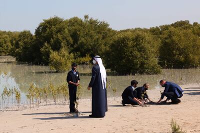 Sheikh Khaled bin Mohamed, Crown Prince of Abu Dhabi, and the UK's Prince William plant trees with school children at the Jubail Mangrove Park in Abu Dhabi, in February 2022. AFP