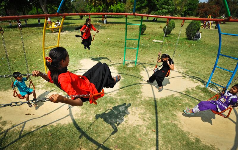 Young women from the Red Brigade play on swings in a public park in the city of Lucknow. The Red Brigade was formed in November 2010 to fight back against a growing number of sexual attacks on women in the Madiyav area of the city of Lucknow, in Uttar Pradesh state, India.
The group of young women wear distinctive red and black salwar kameez. Most have been victims of sexual assault and have resolved that they will take no more. They take direct action against their tormentors and now when a local man steps out of line, he can expect a visit from the Red Brigade and a thrashing.