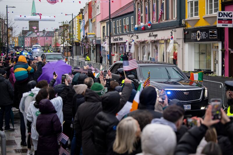People welcome Mr Biden as he arrives by car in Dundalk, County Louth, on April 12. EPA