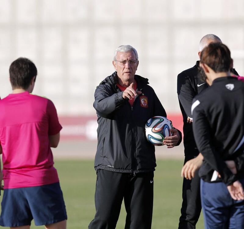 Manager Marcello Lippi, centre, has been a big reason for Guangzhou Evergrande’s recent rise. Christophe Ena / AP Photo

