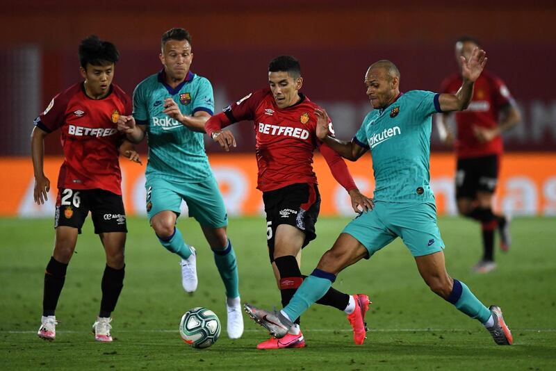 Takefusa Kubo of Mallorca battles for possession with Arthur Melo of Barcelona. Getty Images