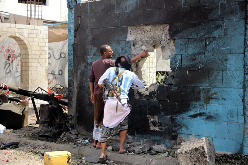 Soldiers inspect the site of a car bomb attack that targeted a police station.  EPA