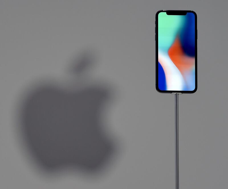 (FILES) This file photo taken on September 12, 2017 shows an iPhone X during a media event at Apple's new headquarters in Cupertino, California. 
Apple announced on January 17, 2018, it would pay about $38 billion in taxes -- likely the largest payment of its kind -- on profits repatriated from overseas as it boosts investments in the United States. / AFP PHOTO / Josh Edelson