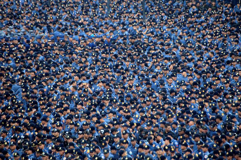 Members of the Philippine National Police (PNP) gather as they prepare for deployment for security during the send-off ceremony for the 31st Association of Southeast Asian Nations (ASEAN) Summit this month at Rizal Park in metro Manila. Romeo Ranoco / Reuters