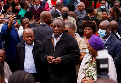 President Cyril Ramaphosa meets with people who lost family members during flooding in Clermont, Durban, on Wednesday. Reuters