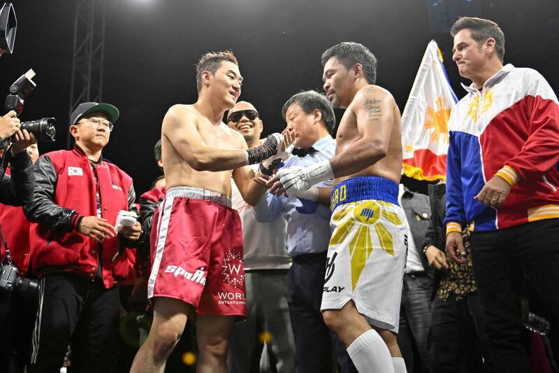 Manny Pacquiao and DK Yoo shake hands after their exhibition boxing match. AFP