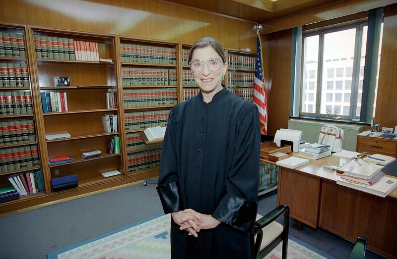 In 1993, then Judge Ruth Bader Ginsburg poses in her robe in her office at U.S. District Court in Washington. Earlier, the Senate voted 96-3 to confirm her as the 107th justice and the second woman to serve on the Supreme Court. Ruth Bader Ginsburg died at her home in Washington, on Sept. 18, 2020, the Supreme Court announced. AP