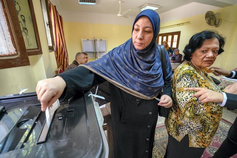 March 27, 2018 -- Cairo-- A woman casts her vote at a polling station in Shubra. (Dana Smillie for The National)