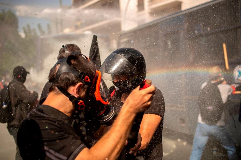 Police use a water cannon against the protesters. AFP