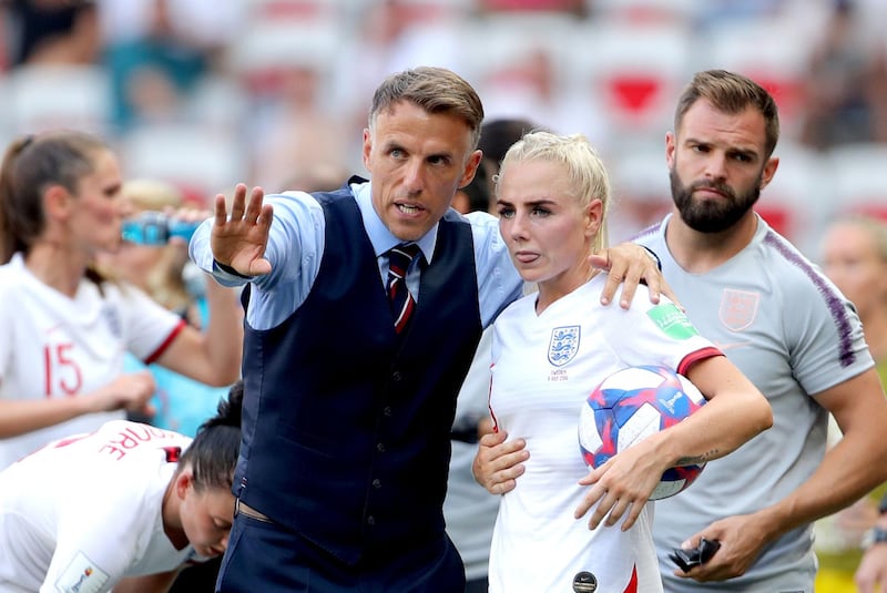 Phil Neville, pictured with Alex Greenwood, has stepped down as manager of England's women with immediate effect. PA