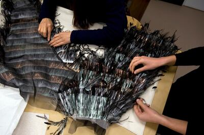 A handout photo of the dress being assembled at Chanel Ateliers (Courtesy: Chanel)

The pieces embroidered by the Montex ateliers, and those covered with feathers and lurex fringes by the LemariŽ ateliers, are sent back to the Chanel ateliers to be assembled. 