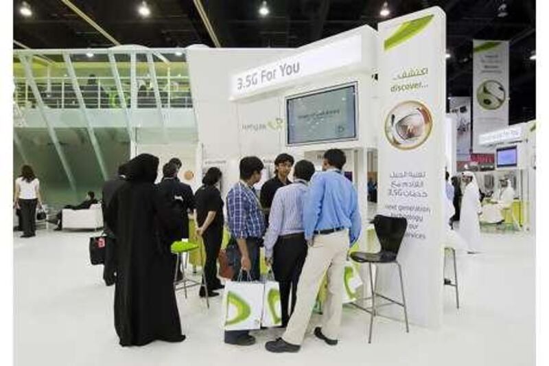 All ears: Attendees gather around the Etisalat booth at the MECOM 2008 Exhibition, Conference and Summit.