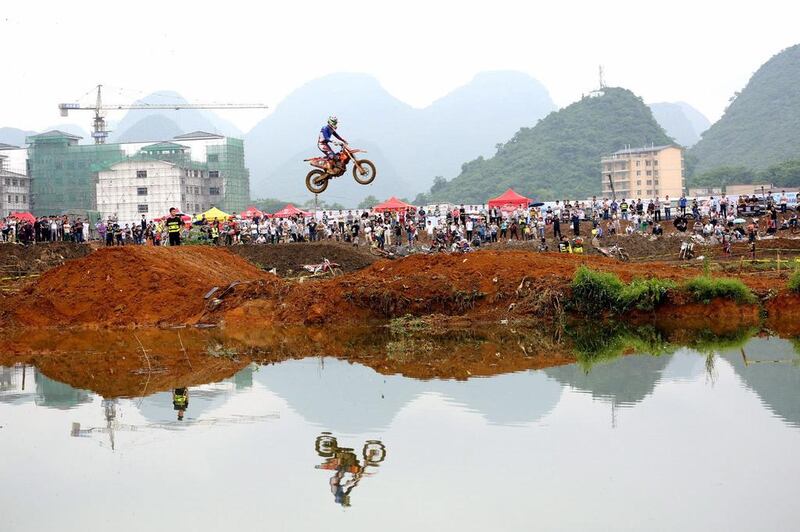 A motorcycle rider in the air during an off-road race at Guilin, China. Picture taken May 20, 2017. Reuters