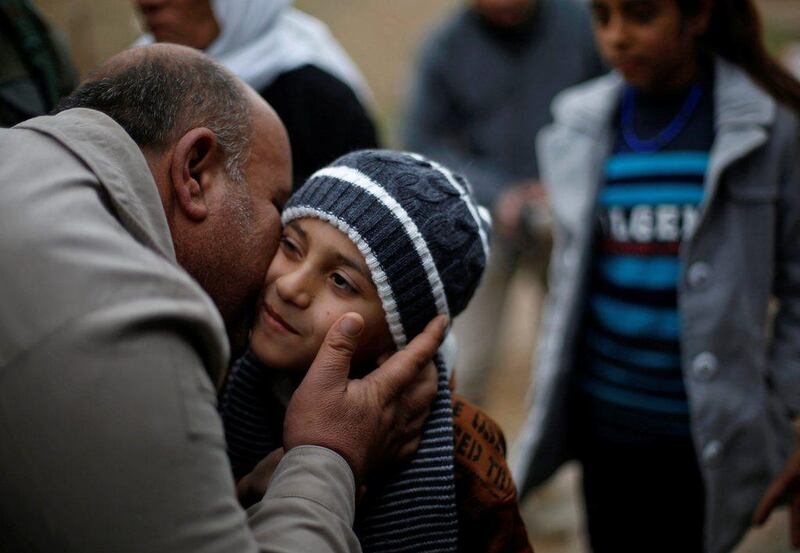 Ayman, a boy from a minority Yazidi community, who was sold by ISIL to a Muslim couple in Mosul, is greeted by a relative after he was returned to his Yazidi family in Duhok, Iraq, on January 31, 2017. Muhammad Hamed / Reuters    

