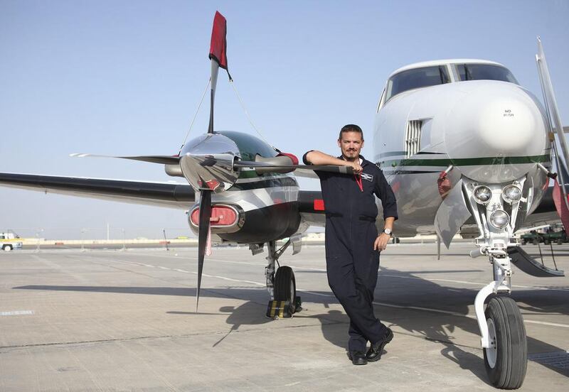 Captain Brendon Allen, of the National Centre of Meteorology and Seismology, with the Beechcraft cloud-seeding aircraft. Lee Hoagland / The National