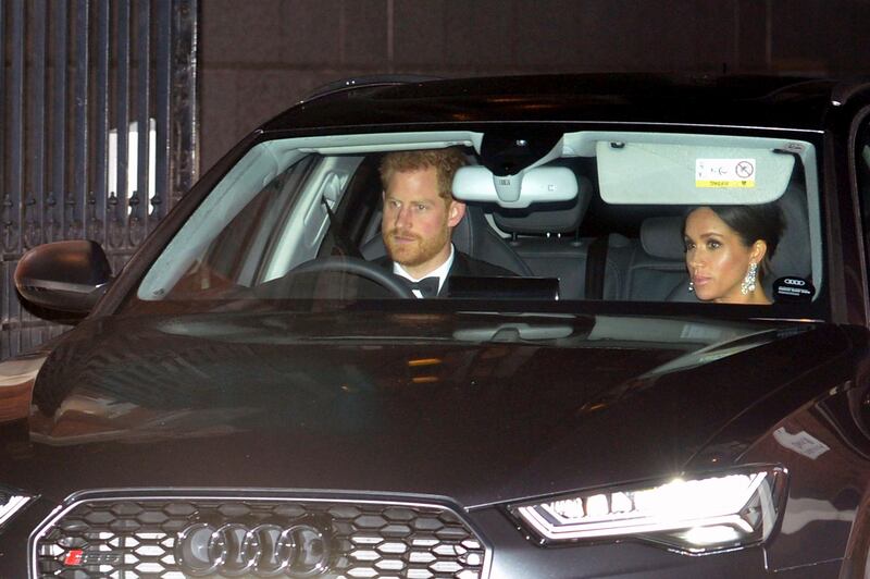 Prince Harry and Meghan, Duchess of Sussex, arrive at Buckingham Palace for Prince Charles's 70th birthday party. PA via AP