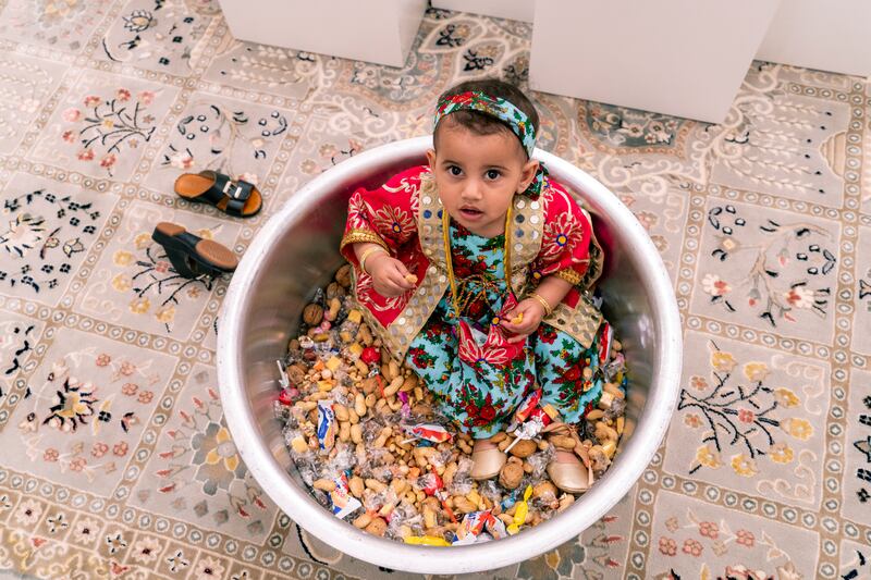 Lulua inside the large aluminum vessel with nuts and candy, which are handed out to the families' children