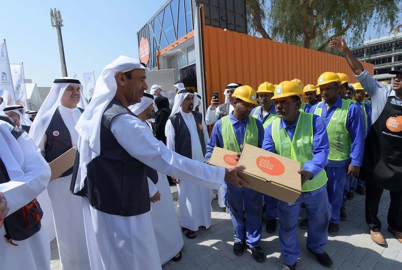 Food is handed out to workers on World Food Day. Dubai Municipality