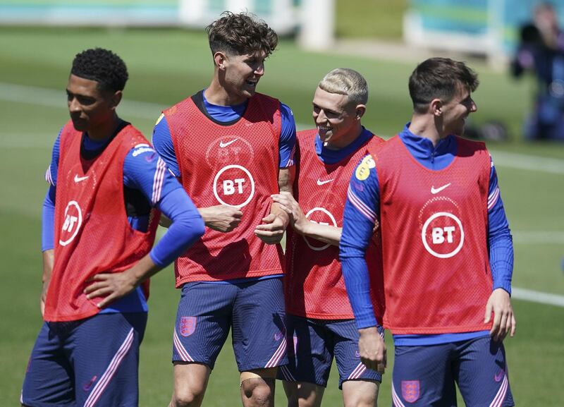 England defender John Stones, second left, joking around with Phil Foden. PA