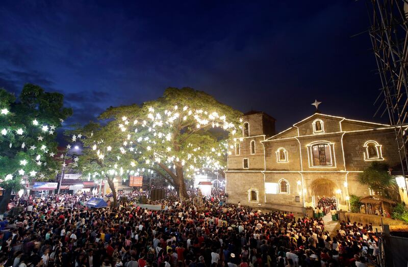 Catholics attend the traditional Misa de Gallo (Dawn Mass) in front of a church in Las Pinas City, south of Manila, Philippines. EPA