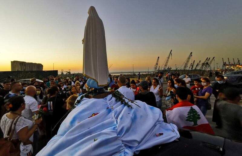 People attend a prayer near the site of a massive explosion in Beirut's port area, Lebanon. Reuters
