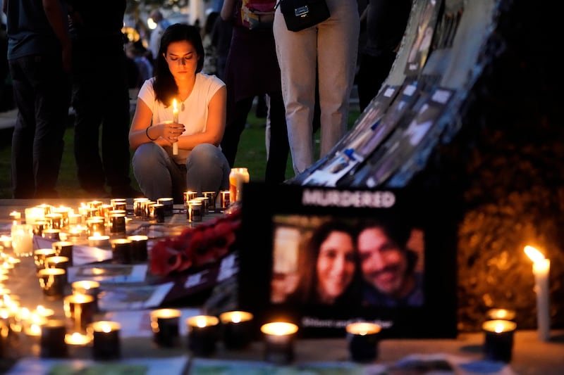 People light candles for Israel in London. AP