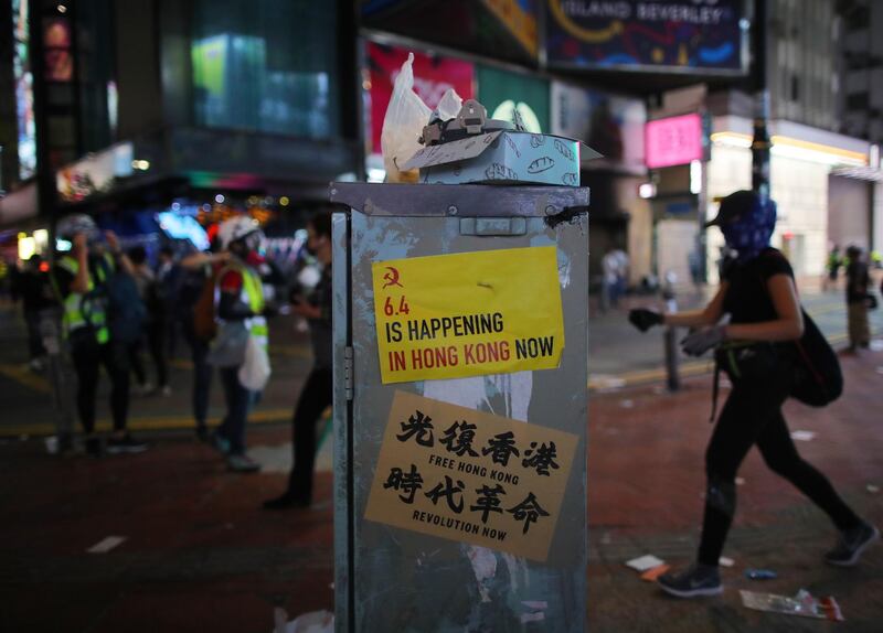 Anti-government posters are seen pasted on a structure in Causeway Bay. EPA