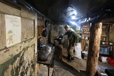 A Ukrainian soldier cooks in in a shelter near a fighting position on the line of separation from pro-Russian rebels near Debaltsevo, Donetsk region, Ukraine. AP