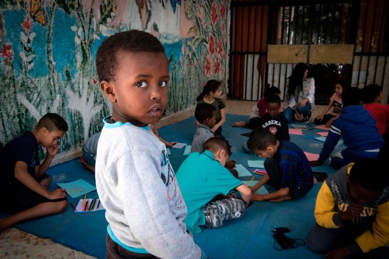 Sudanese children, who fled from the clashes in Libya, draw at a school in Tripoli. AFP