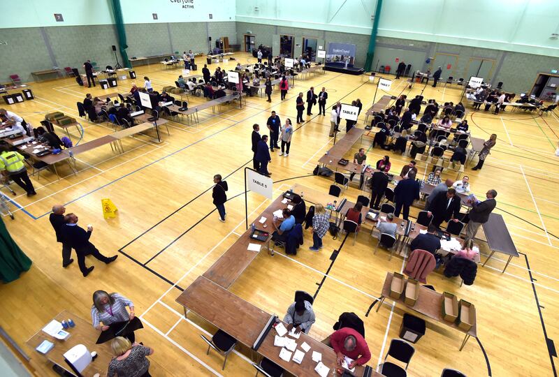 Volunteers sort ballot papers before counting at Basildon Sporting Village in Essex. PA