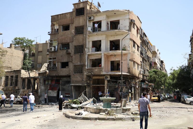epa06061471 A view of a damaged building after a car bomb explosion near the al-Ghadir Square in the al-Amara neighborhood in Damascus, Syria, 02 July 2017. According to the state TV, three car bomb blasts rocked the capital  Damascus on 02 July that killed at least eight people and wounded a dozen others. It said that three car bombs went off at the Airport Road and al-Amara neighborhood in Damascus city. It indicated that the authorities chased the three cars and managed to intercept two of them near the entrance of Damascus city at the airport roundabout and destroyed them, but the third car managed to arrive in the capital and the suicide bomber on board detonated it, killing a number of people and injuring others.  EPA/YOUSSEF BADAWI