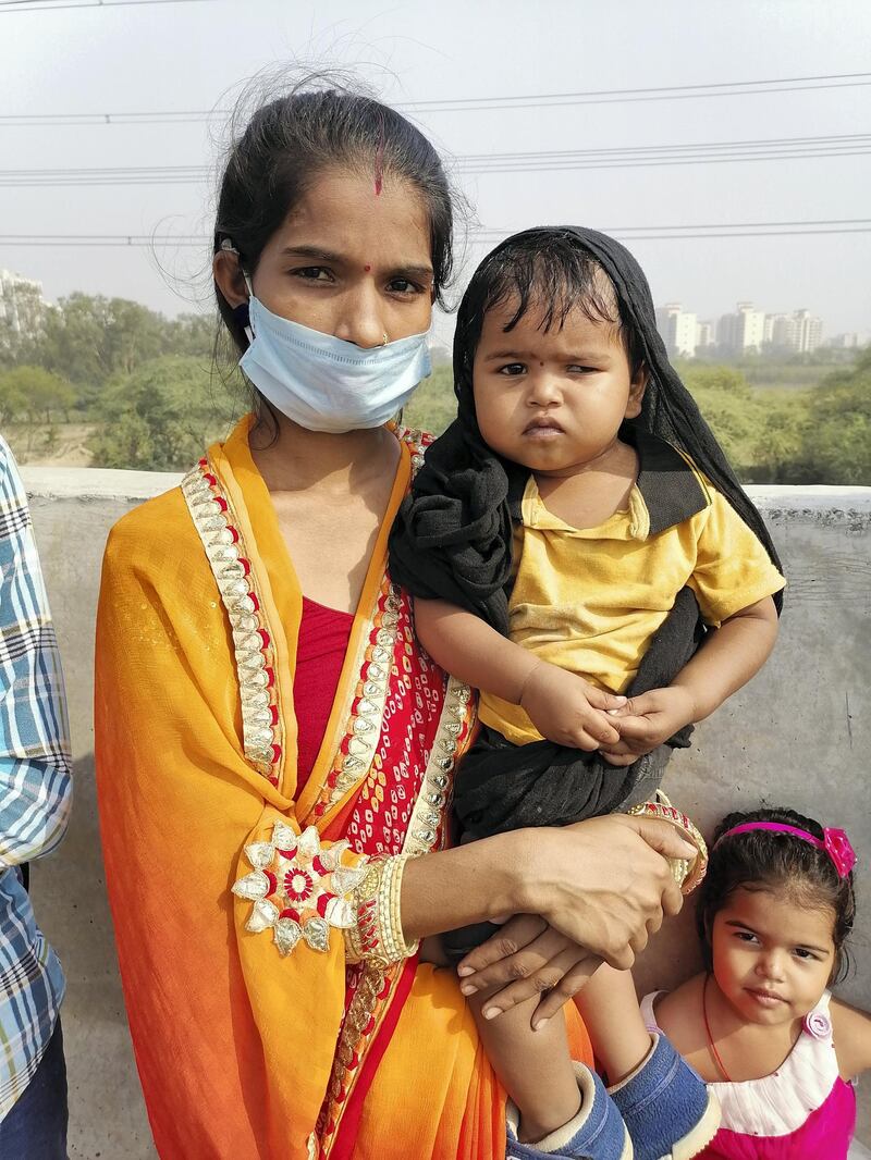 Pushpa Kumari, 25, pacifies her son along a highway near Ghaziabad city. Taniya Dutta/The National