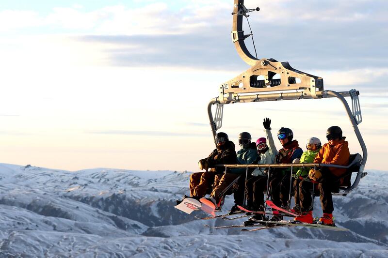 Skiers and snowboarders ride chairlifts on opening day in Cardrona, New Zealand. Queenstown's ski season is officially open from today. Getty Images