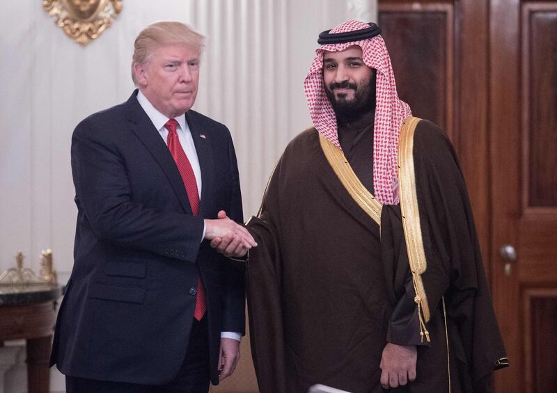 (FILES) This file photo taken on March 14, 2017 shows US President Donald Trump and Saudi Deputy Crown Prince and Defense Minister Mohammed bin Salman shaking hands in the State Dining Room before lunch at the White House in Washington, DC.
Donald Trump will host Saudi Arabia's crown prince in Washington on March 20, 2018, giving the president a receptive audience to denounce rival Iran and a chance to take stock of significant changes the prince is engineering in the kingdom.
 / AFP PHOTO / NICHOLAS KAMM