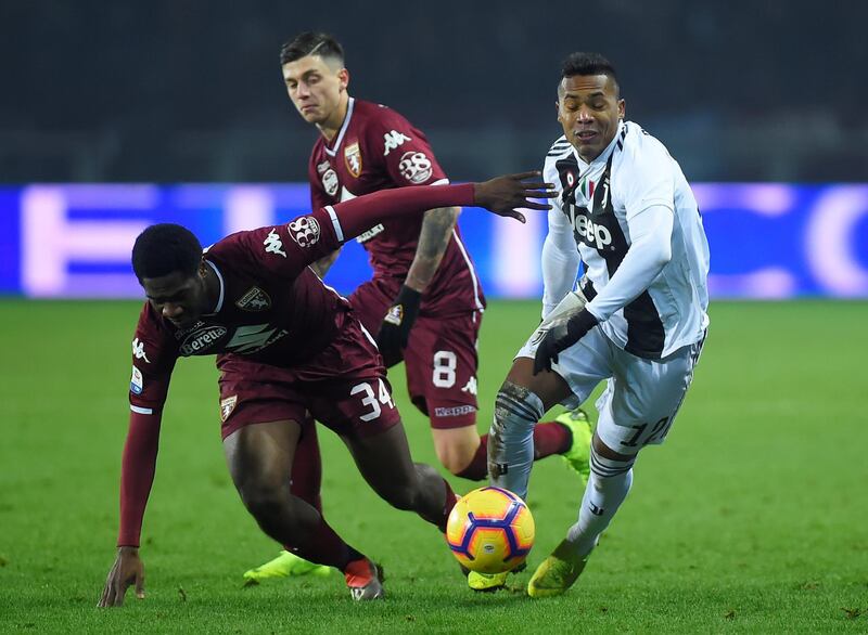 Juventus full-back Alex Sandro in action with Torino's Ola Aina and Daniele Baselli. Reuters