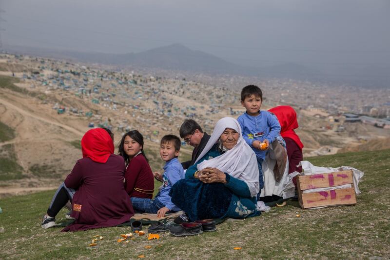 Fasel Begum, 67 sits with her family on a hill outside Kabul to celebrate Nowruz.