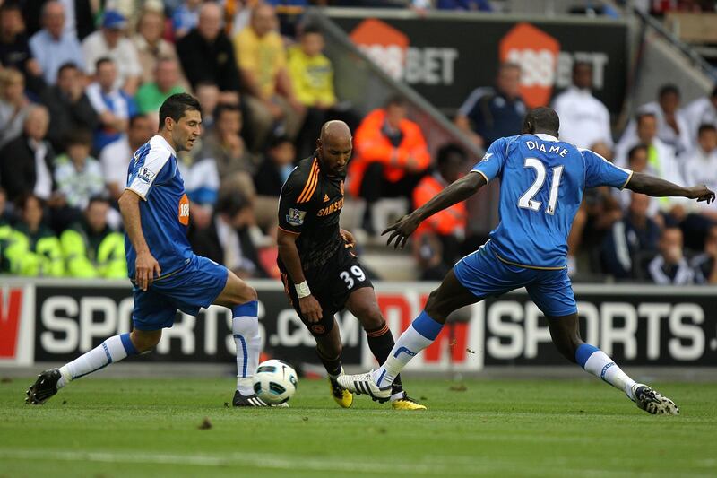 Chelsea's Nicolas Anelka (centre) takes the ball past Wigan Athletic's Mohamed Diame (right) and Antolin Alcaraz (left)   (Photo by John Walton - PA Images via Getty Images)