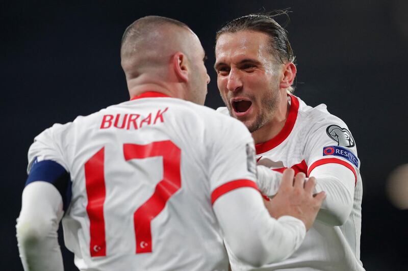 Turkey's forward Burak Yilmaz (L) celebrates with Turkey's defender Caner Erkin after scoring his second goal during the FIFA World Cup Qatar 2022 qualification Group G football match between Turkey and The Netherlands at the Ataturk Olympic Stadium, in Istanbul, on March 24, 2021.  / AFP / POOL / MURAD SEZER
