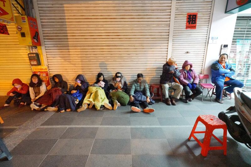 Costumers escaped from the damaged Marshal Hotel sit outside. A hotel on the east coast of Taiwan has collapsed after a 6.4-magnitude earthquake, the government said. Yang Jen-Fu / AFP