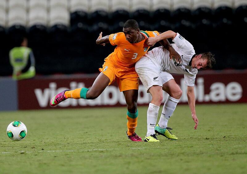 Meite Yakou, left, of Ivory Coast tangles with New Zealand's Cory Brown during their FIFA Under 17 World Cup match on Wednesday. Satish Kumar / The National