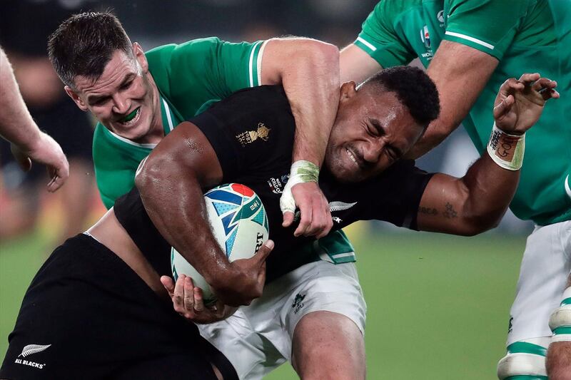 New Zealand's Sevu Reece is defended by Ireland's Johnny Sexton during the Rugby World Cup quarterfinal match at Tokyo Stadium between New Zealand and Ireland in Tokyo, Japan. AP Photo