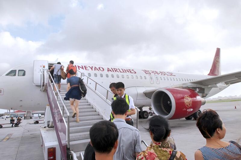 Passengers board an Airbus A320 jet plane of Juneyao Airlines at the Changsha Huanghua International Airport in Changsha city, central Chinas Hunan province. The carrier is to buy Dreamliners. Wang Qian.