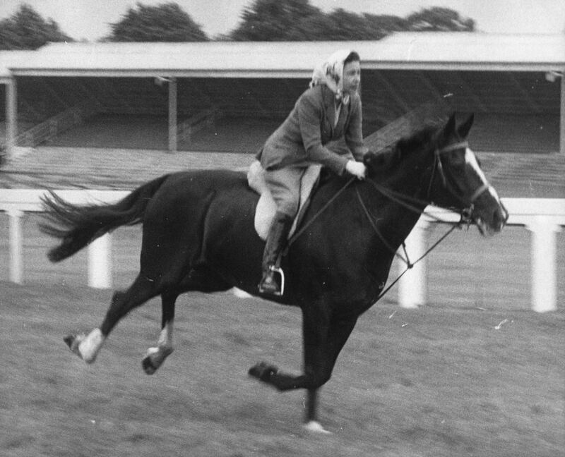 Queen Elizabeth on the racecourse before the opening of the third day of the Royal Ascot meeting, where she took part in an unofficial 'race' and finished fourth to other members of her party of seven. June 1960. PA 