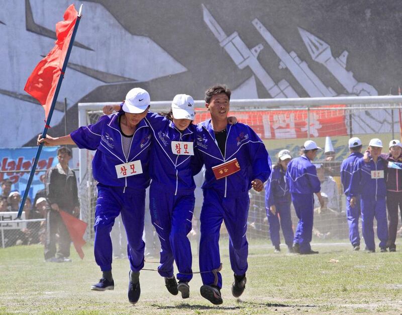 North Korean workers, with their legs tied together, take part in a May Day competition at the Pyongyang Thermal Power Complex. Jon Chol Jin / AP Photo