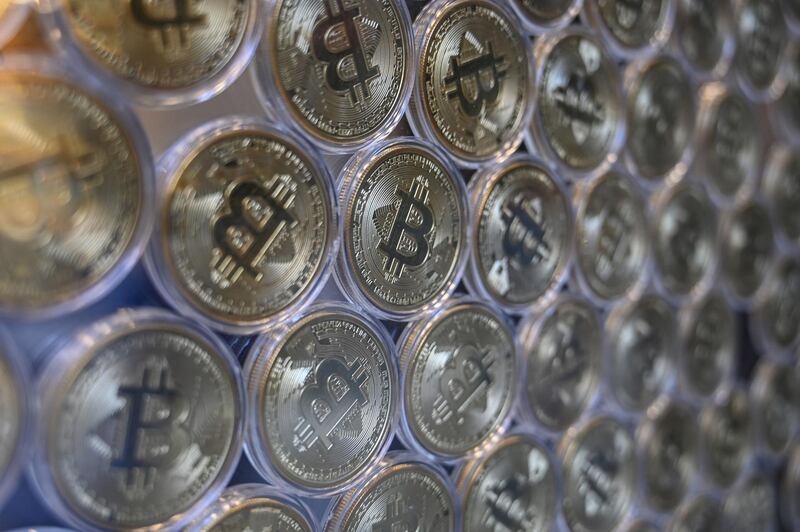 (FILES) In this file photo taken on December 17, 2020 a physical imitation of a Bitcoin is pictured at a crypto currency "Bitcoin Change" shop, near the Grand Bazaar, in Istanbul.  After the latest wild ride took the poster child of cryptocurrencies above $40,000 before a stomach-churning plunge, the million dollar question won't go away: how much is bitcoin actually worth? The virtual currency barrelled to new highs to rise more than 400 percent over the past year, before promptly sliding some 20 percent and then settling around $36,000. / AFP / Ozan KOSE
