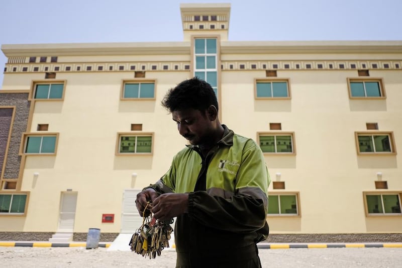 A watchmen sorts through his stock of keys outside one of the labour accommodation buildings in the Al Hail area of Fujairah. Antonie Robertson / The National 