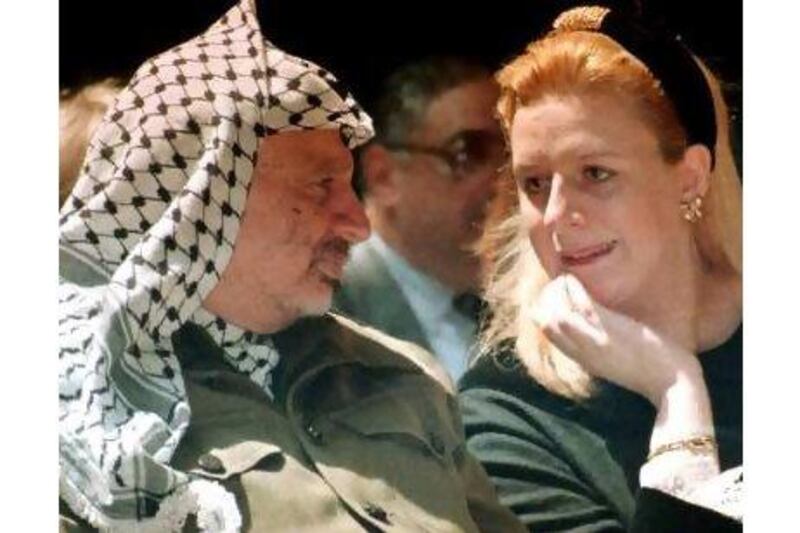 A reader says we should find the cause of death of Yasser Arafat, pictured in 1995 with his wife Suha. Nabil Judah / AP