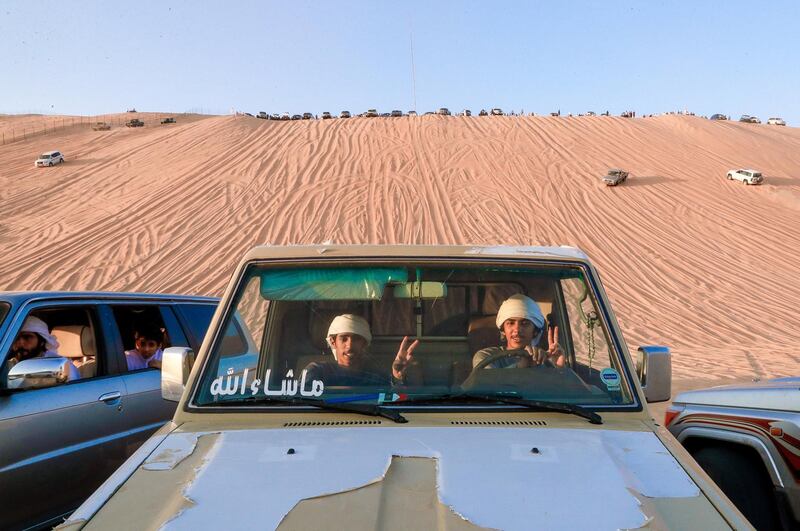 Abu Dhabi, United Arab Emirates, January 2, 2020.  Desert 4x4 enthusiasts enjoy the view of the peeks of the  the Mureeb Dunes from the base at the LIWA International Festival 2020.
Victor Besa / The National
Section:  NA
Reporter:  Haneen Dajani