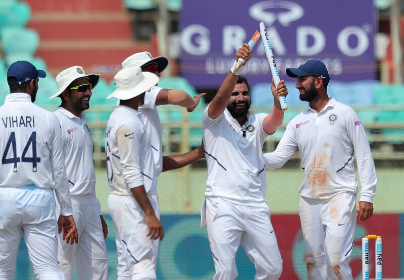 Indian bowler Mohammed Shami, with out cap, celebrates by showing broken wicket after dismissing South Africa's Dane Piedt during the fifth day of the first cricket test match against South Africa in Visakhapatnam, India, Sunday, Oct. 6, 2019. (AP Photo/Mahesh Kumar A.)